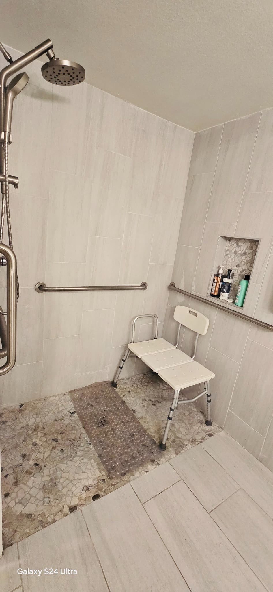 Accessible walk-in shower with grab bars and shower chair